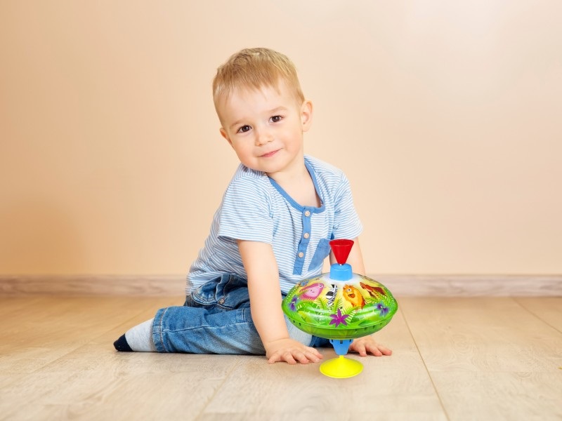 Portrait of a two years old child sitting on the floor. Pretty little boy at home